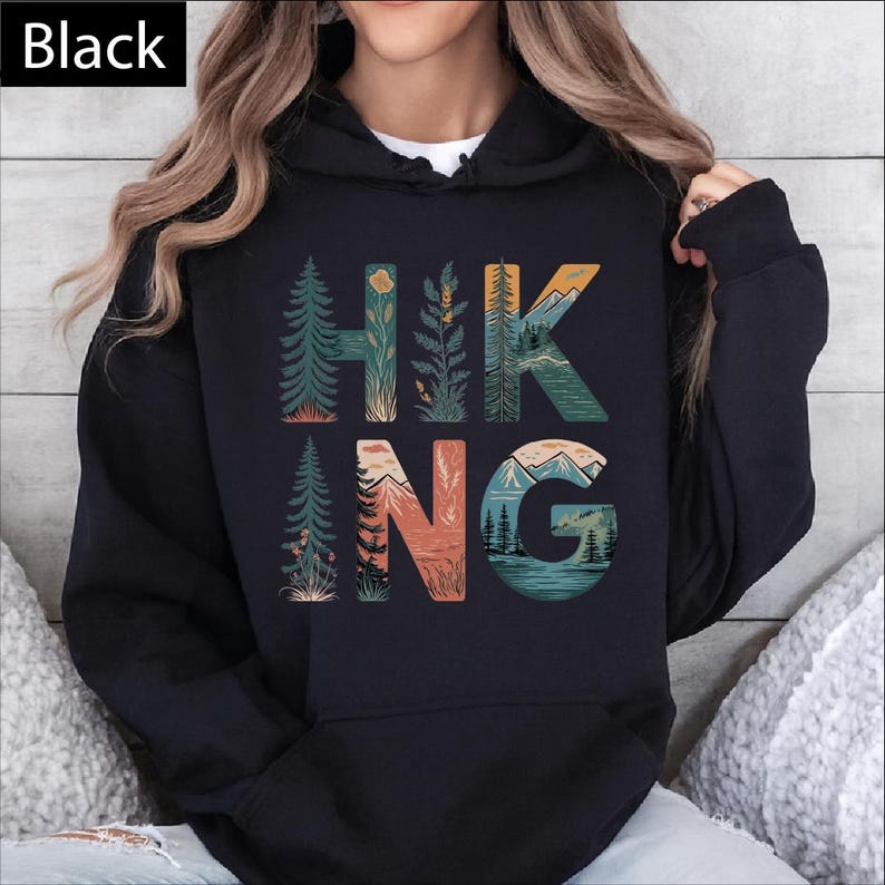 A person wearing a black hoodie with the word "HIKING" printed on it.