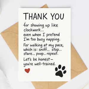 May include: A white greeting card with the words "THANK YOU" in black. The card has a humorous message about a pet's behavior, a red heart, and a black paw print. The card is inside a brown envelope.