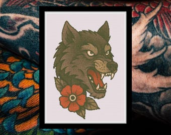 Peut inclure: Un modèle de point de croix représentant une tête de loup gris grognant avec des dents acérées et la gueule ouverte, agrémenté d'une fleur rouge unique avec des feuilles vertes à la base. Le motif est sur un fond quadrillé blanc encadré de noir.