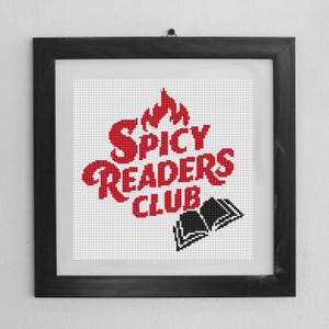 May include: A framed cross-stitch design with the text "The Spicy Readers Club" in red lettering and a black silhouette of an open book.