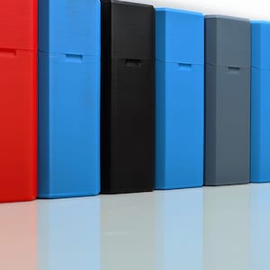 May include: A row of eight slim, rectangular boxes in various colours, including red, blue, black, and grey. The boxes are all the same size and shape, and they are arranged in a line from left to right.