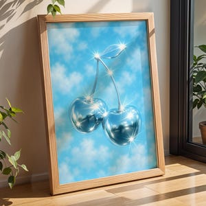 May include: A framed print of two shiny, silver cherries against a blue sky with white clouds. The cherries are 3D and have a reflective surface.