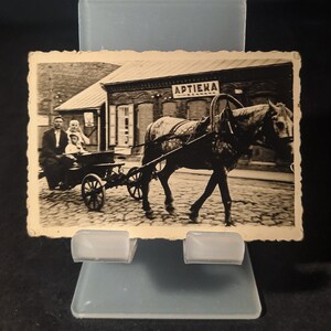 Antike lettische Fotografie, Familienleben vor dem Krieg, Pferdewagen, ländliches Lettland, historische Kleinstadt-Motiv, Drogerie-Gebäude