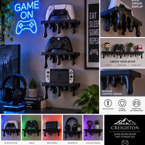 May include: A set of three black wall-mounted shelves featuring a decorative dripping paint design. Each shelf holds a gaming controller or console. The shelves are displayed in various configurations with gaming accessories and collectibles.