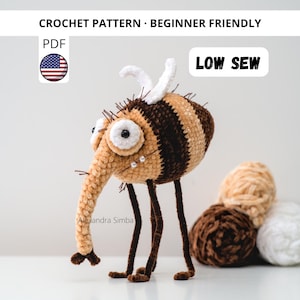 Puede incluir: Un juguete de mosca de ganchillo hecho a mano, con un hocico largo, ojos grandes y un cuerpo a rayas en tonos marrones y beige. La imagen incluye el texto "CROCHET PATTERN - BEGINNER FRIENDLY" y "LOW SEW".