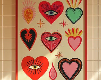 May include: A framed art print featuring a collection of stylized hearts in various colors and designs. The hearts include eye motifs, flames, and decorative patterns. The print is set against a cream background and framed in red.