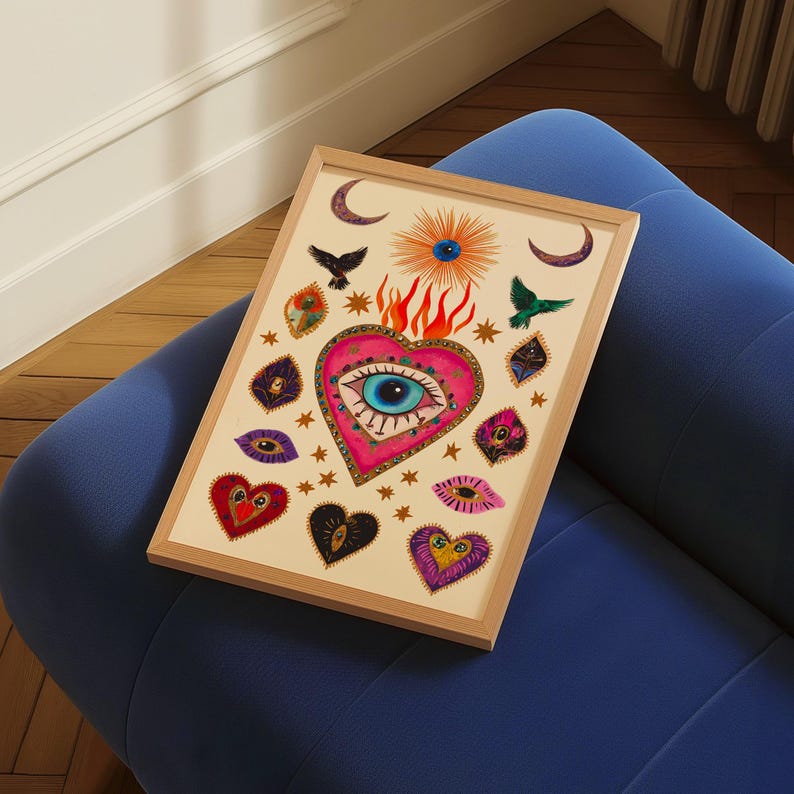 A vibrant mystical poster featuring a flaming heart with a central blue evil eye surrounded by celestial symbols, stars, moons, and birds. Embellished with jewel-like details and bright colors, this maximalist artwork blends folk art and spiritual symbolism, making it a bold bohemian wall decor piece.Mystical Eye Art, Spiritual Decor, Celestial Folk Print, Bohemian Wall Art, Protective Eye Print, Dopamine Decor, Maximalist Art, Sacred Heart Art, Colorful Mystical Decor, Eclectic Spiritual Print