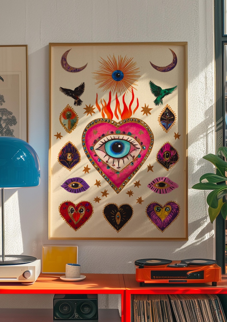A vibrant mystical poster featuring a flaming heart with a central blue evil eye surrounded by celestial symbols, stars, moons, and birds. Embellished with jewel-like details and bright colors, this maximalist artwork blends folk art and spiritual symbolism, making it a bold bohemian wall decor piece.Mystical Eye Art, Spiritual Decor, Celestial Folk Print, Bohemian Wall Art, Protective Eye Print, Dopamine Decor, Maximalist Art, Sacred Heart Art, Colorful Mystical Decor, Eclectic Spiritual Print