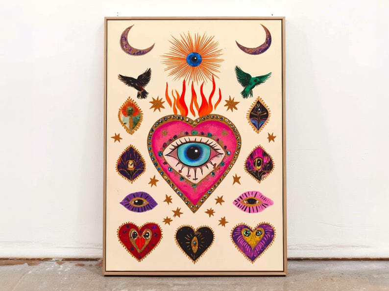 A vibrant mystical poster featuring a flaming heart with a central blue evil eye surrounded by celestial symbols, stars, moons, and birds. Embellished with jewel-like details and bright colors, this maximalist artwork blends folk art and spiritual symbolism, making it a bold bohemian wall decor piece.Mystical Eye Art, Spiritual Decor, Celestial Folk Print, Bohemian Wall Art, Protective Eye Print, Dopamine Decor, Maximalist Art, Sacred Heart Art, Colorful Mystical Decor, Eclectic Spiritual Print