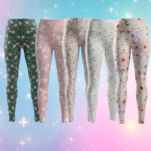 May include: Five pairs of floral print leggings in various colors. The leggings feature different floral patterns, including green, pink, and white backgrounds with delicate flower designs. The leggings are made of a soft, stretchy material.