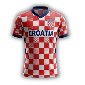 May include: A red and white checkered Croatia soccer jersey with the word "CROATIA" across the chest. The jersey has a blue V-neck collar and blue sleeve cuffs. The Croatian coat of arms is on the upper chest.