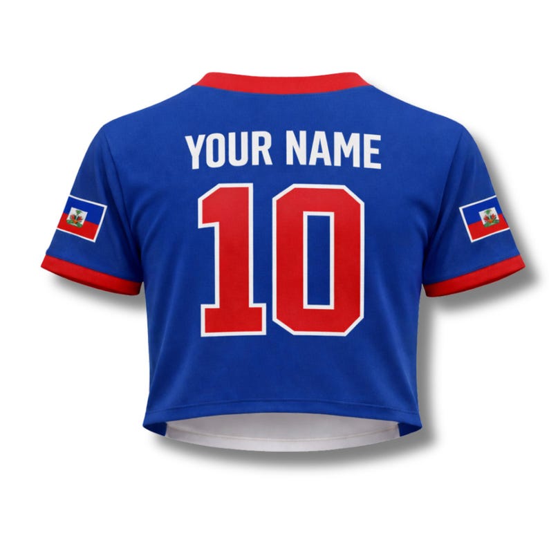 May include: Blue crop top jersey with red trim and the number 10 in red with a white outline. The text "YOUR NAME" is above the number. The Haitian flag is on each sleeve.