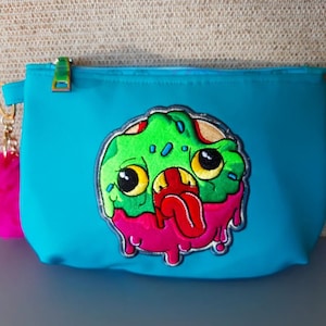 Zombie Donut embroidered purse with custom zipper and furry pompom keychain