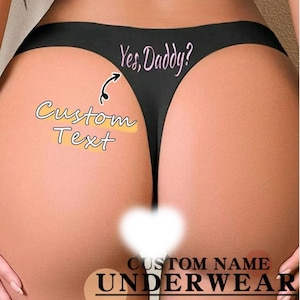 May include: Black thong underwear with the text "Yes, Daddy?" in pink script. The words "Custom Text" are also visible, along with the words "Custom Name Underwear".