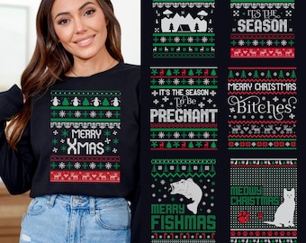 May include: A black sweatshirt with a green and red Christmas design. The design includes snowmen, trees, and the text "Merry Xmas." The image also shows other Christmas sweater designs with various holiday-themed graphics and text.