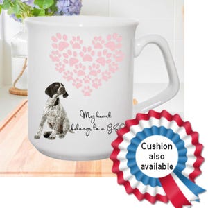 May include: White ceramic mug featuring a pink paw print heart design and an illustration of a German Shorthaired Pointer dog. The mug reads "My heart belongs to a GSP".