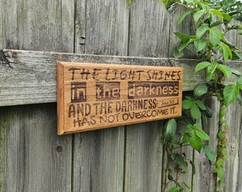 Bible Plaque "The Light Shines" - Hardwood Engraved Christian Wall Art Decoration - 13.5x5in - John 1:5 Scripture Passage