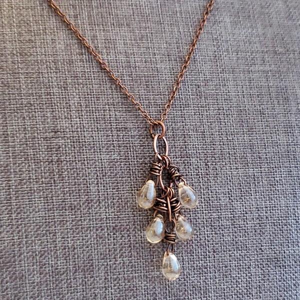 May include: A copper chain necklace with a pendant featuring a cluster of clear glass teardrop beads wrapped in copper wire.