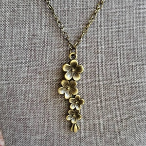 Bronze Plum Blossom Pendant Necklace: Long Antiqued Brass Floral Charm