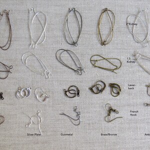 May include: A collection of various earring findings in different metal finishes, including copper, silver plate, gunmetal, brass/bronze, and antique silver. Styles include kidney, lever-back, and French hook designs. The image shows a variety of shapes and sizes.
