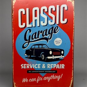 May include: A rectangular metal sign with a distressed finish. The sign features the words "CLASSIC Garage" in white, a blue diamond shape with a black car illustration, and the text "SERVICE & REPAIR". The sign reads "We can fix anything!"