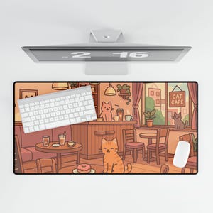 May include: A rectangular mousepad featuring a cartoon cat cafe scene with a white keyboard and mouse. The illustration includes cats, tables, chairs, and the text "CAT CAFE". The color palette is warm, with shades of brown, orange, and beige.