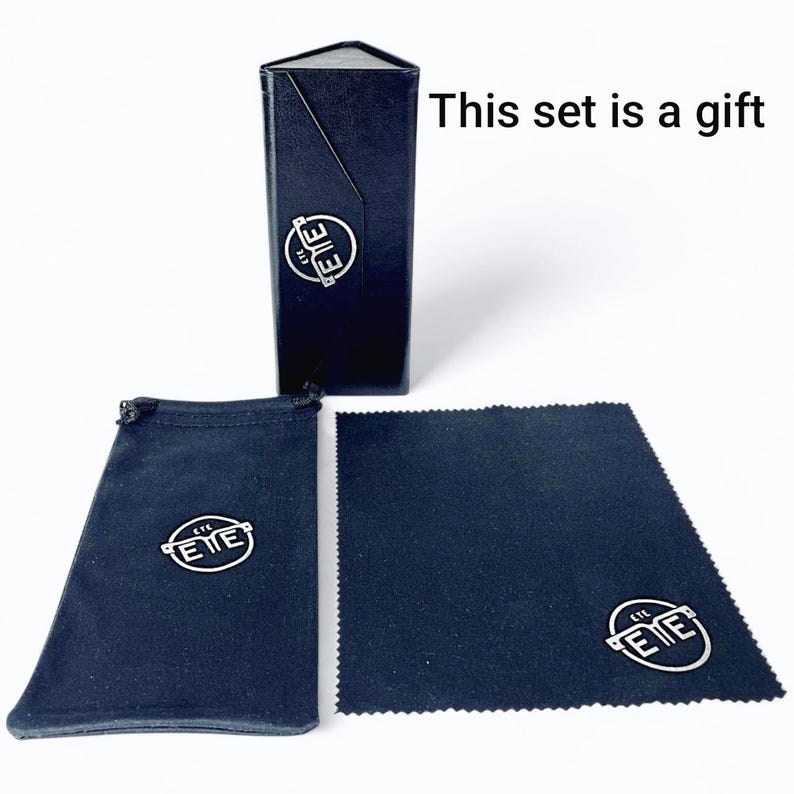 May include: A black eyewear set includes a triangular case, a drawstring pouch, and a cleaning cloth. Each item features a silver logo. The text "This set is a gift" is displayed.