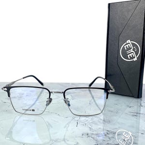 Titanium rectangular eyeglass frames in black and silver with golden temple accents. Suitable for prescription or fashion lenses. Includes hard ETE case, soft pouch, and cleaning cloth. Lightweight, durable, and hypoallergenic design for men and women. Ideal as a stylish gift with fast worldwide shipping.