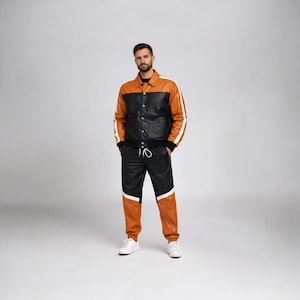 May include: A two-tone leather jacket and matching pants set. The jacket is black and tan with white stripes on the sleeves. The pants are black with tan panels. The outfit is worn with white sneakers.