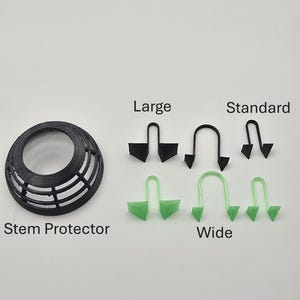 May include: An assortment of black and green 3D-printed stem protectors and accessories. Includes a black stem protector, black and green large and standard stem protectors, and green wide stem protectors. Text on the image reads "Stem Protector", "Large", "Standard", and "Wide".