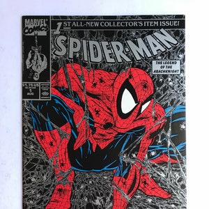 May include: A Spider-Man comic book cover featuring the hero in a red and blue suit, crouched amidst a web. The title "Spider-Man" is in large, silver lettering. The cover includes the text "TORMENT" and "PART ONE OF FIVE".