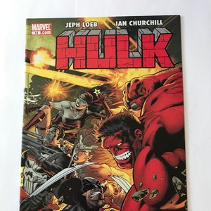 Op de afbeelding: Marvel Hulk stripboek, nummer 14, met een dynamische coverillustratie van de rode Hulk en andere personages. De titel "Hulk" staat prominent in rode blokletters. De strip is beoordeeld met T+.