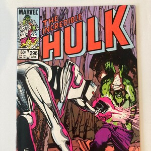 May include: Comic book cover for "The Incredible Hulk" #296. Features a green Hulk character in purple pants, battling a metallic figure. Bold orange title text. Includes the Marvel Comics logo and issue details.