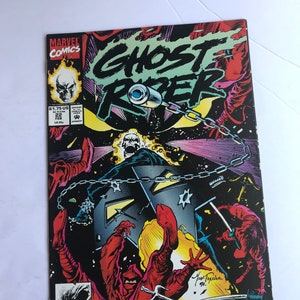 May include: A vintage comic book featuring Ghost Rider. The cover art showcases a fiery skull, chains, and action-packed illustrations in a dark, dynamic style. The Marvel Comics logo is visible.