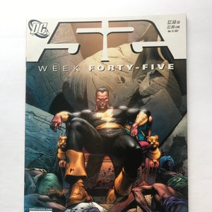 May include: Black Adam, a superhero, sits on a throne in a dark, ancient setting. He wears a black and gold costume with a lightning bolt symbol on his chest. The text "WEEK FORTY-FIVE" is at the top of the image.