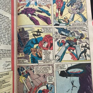 May include: Comic book page featuring Transformers and Spider-Man. Panels depict robot characters in action, with speech bubbles and dynamic illustrations. The comic is from the 1970s.