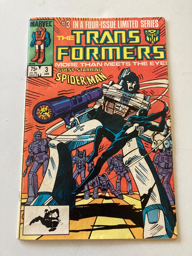 May include: Comic book cover for The Transformers #3, featuring a dynamic illustration of Transformers and Spider-Man. The cover is predominantly orange, with text and images in blue, black, and white. The Marvel logo is visible in the upper left corner.