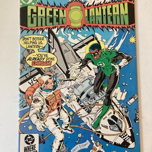 May include: A vintage Green Lantern comic book issue 187 from April 1985, featuring a cover illustration of a space shuttle, astronauts, and the Green Lantern character. The text reads "Green Lantern," "Don't bother helping us, Lantern--you've already done enough!"