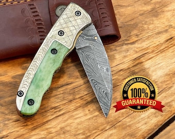 Custom handmade Damascus steel folding knife color bone handle. engraved on handle.