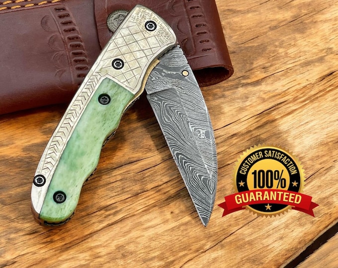 Custom handmade Damascus steel folding knife color bone handle. engraved on handle.