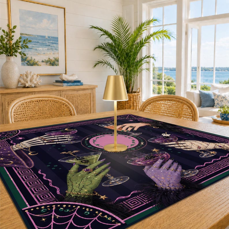 May include: A square fabric tablecloth featuring a dark purple and black striped background with a repeating pattern of various hands holding cocktail glasses, including skeletal, green, and purple hands, accented with gold stars and spiderwebs.