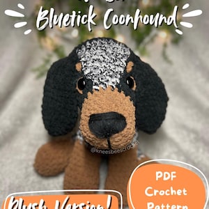 May include: A plush, no-sew Bluetick Coonhound crochet pattern. The dog has black ears, a black and white head, and a brown snout and legs. The text reads "No-Sew Bluetick Coonhound" and "Plush Version!" with an orange circle that says "PDF Crochet Pattern".