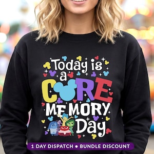 May include: Black sweatshirt with the text "Today is a CORE MEMORY Day" in colourful letters and a Mickey Mouse head. The sweatshirt also features characters from the movie Inside Out.