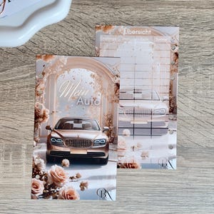 May include: Two planner inserts featuring a luxury car design. One insert displays a gold car with the text "Mein Auto" surrounded by roses. The other insert has a similar car design with the word "Übersicht" at the top.