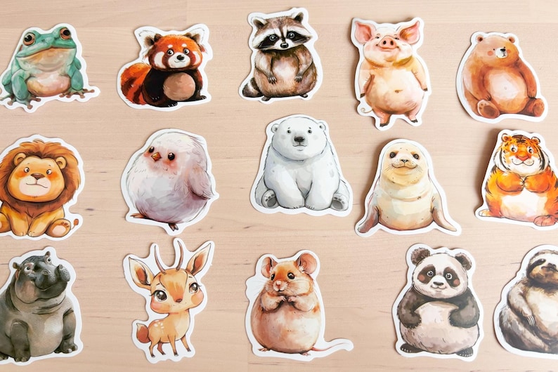 K&ouml;nnte beinhalten: Eine Sammlung farbenfroher Tieraufkleber, darunter ein Frosch, ein roter Panda, ein Waschb&auml;r, ein Schwein, ein B&auml;r, ein L&ouml;we, ein Vogel, ein Eisb&auml;r, eine Robbe, ein Tiger, ein Nilpferd, ein Reh, eine Maus, ein Panda und ein Faultier.