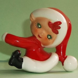 May include: A white ceramic mug with a black handle and the text "But First, Coffee" in a bold, black font. The mug is set against a neutral background, highlighting its simple design.