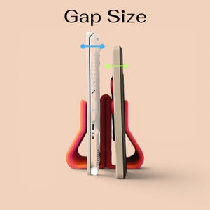 May include: A pink and orange U-shaped stand holding a white laptop and a dark tablet upright. The text Gap Size appears at the top. Blue and green horizontal arrows indicate the width of the space between the devices and the stand structure.