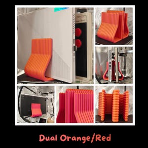 May include: A 3D printed laptop stand featuring a ribbed, U-shaped design in a vibrant orange and red gradient. The stand is shown in multiple angles, supporting a white laptop and positioned next to a white electronic device with red buttons.