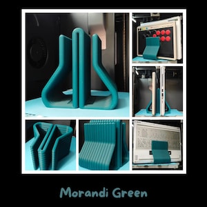 May include: A Morandi green 3D printed stand with a ribbed texture, designed to hold electronic devices upright. The stand features a U-shaped profile with a central slot, shown supporting a game controller and a laptop in various orientations.