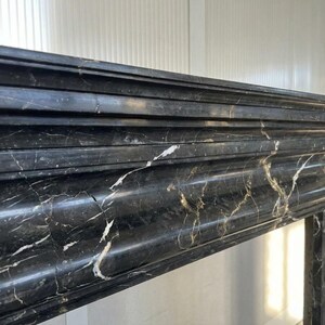 Handcarved Nero Marquina marble fireplace mantel by Marblyart, custom made to order — photo 3 of 11